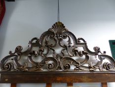 AN IMPRESSIVE CARVED BAROQUE STYLE HEADBOARD WITH SILVERED SHELL AND PIERCED SCROLLWORK