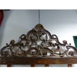 AN IMPRESSIVE CARVED BAROQUE STYLE HEADBOARD WITH SILVERED SHELL AND PIERCED SCROLLWORK