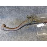 A MIDDLE EASTERN FLINTLOCK LONG GUN WITH FULL STOCK AND SHAPED BUTT.