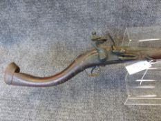 A MIDDLE EASTERN FLINTLOCK LONG GUN WITH FULL STOCK AND SHAPED BUTT.