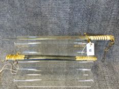 A GEORGE V NAVAL MIDSHIPMAN'S DIRK WITH ETCHED BLADE BY GIEVES COMPLETE WITH SCABBARD BEARING OWNERS