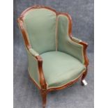 A CARVED LOUIS XV STYLE HIGHBACK ARMCHAIR WITH SCROLL MOULDED FRAME AND CABRIOLE LEGS.