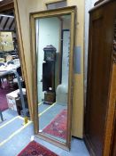 AN ANTIQUE GILT FRENCH STYLE PIER MIRROR. 164 x 58cms.