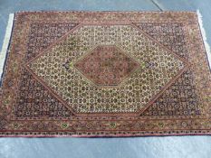 A PERSIAN RUG OF TABRIZ DESIGN. 172 x 112cms.