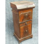 A 19th.C.TOLE PAINTED TIN WASHSTAND WITH RISING LID AND RECESSED BOWL OVER CUPBOARDS AND DRAWERS. W.