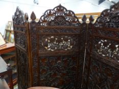 AN ANTIQUE INDIAN CARVED HARDWOOD THREE FOLD FLOOR SCREEN WITH ELABORATE PIERCED AND FOLIATE