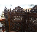 AN ANTIQUE INDIAN CARVED HARDWOOD THREE FOLD FLOOR SCREEN WITH ELABORATE PIERCED AND FOLIATE