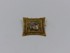 A GEORGE III GOLD AND SPEED PEARL MEMORIAL BROOCH DESIGNED AS AN OVAL SHAPED SEPIA PANEL DEPICTING A