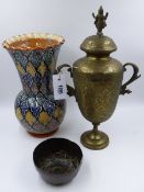 A FINELY ENGRAVED INDIAN BRASS TWIN HANDLES COVERED URN, H.40cms TOGETHER WITH A FIGURAL COPPER BOWL