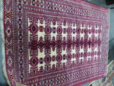 AN ORIENTAL RUG OF TURKOMAN DESIGN. 201 x 151cms TOGETHER WITH A SMALL TEKKE BOKHARA RUG (2)