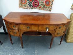 A REGENCY INLAID MAHOGANY BOW FRONT SIDEBOARD WITH CENTRE DRAWER ABOVE TAMBOUR DOORS FLANKED BY DEEP