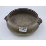 A HEAVY CHINESE BRONZE CENSER WITH MASK HANDLES AND IMPRESSED MARKS TO BASE. D.16cms