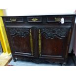 AN ANTIQUE CARVED OAK FRENCH PROVINCIAL CABINET WITH THREE FRIEZE DRAWERS ABOVE PANELLED TWO DOOR