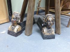 A PAIR OF UNUSUAL CAST IRON FIGURAL ANDIIRONS, EACH DECORATED WITH A PORTRAIT BUST.
