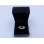 AN 18ct. COMMEMORATIVE MILLENIUM HALLMARKED SAPPHIRE AND DIAMOND THREE STONE RING. THE CENTRE