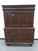 AN EARLY 19th.C.CONTINENTAL OAK SECRETAIRE ABBUTANT WITH FALL FRONT REVEALING FITTED INTERIOR OVER A