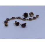 A 9ct. GOLD HALLMARKED GARNET BRACELET TOGETHER WITH A PAIR OF 9ct. STAMPED MATCHING EARRINGS WITH