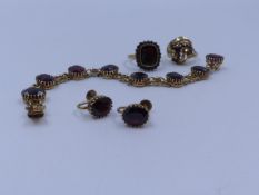 A 9ct. GOLD HALLMARKED GARNET BRACELET TOGETHER WITH A PAIR OF 9ct. STAMPED MATCHING EARRINGS WITH