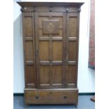 AN INLAID EDWARDAIN PANEL DOOR WARDROBE IN THE ARTS AND CRAFTS STYLE WITH SINGLE DRAWER TO BASE. H.