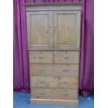A 19th.C.PINE LINEN PRESS WITH PANEL DOORS ENCLOSING SLIDES OVER FIVE DEEP DRAWERS AND PLINTH