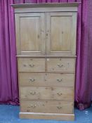 A 19th.C.PINE LINEN PRESS WITH PANEL DOORS ENCLOSING SLIDES OVER FIVE DEEP DRAWERS AND PLINTH