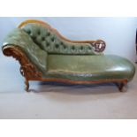 A VICTORIAN CARVED WALNUT CHAISE COVERED IN STUDDED OLIVE GREEN LEATHER ON SHORT CABRIOLE LEGS. W.