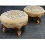 TWO SIMILAR FRENCH CARVED GILTWOOD LARGE ROUND STOOLS WITH FLORAL NEEDLEPOINT SEATS. ELABORATE