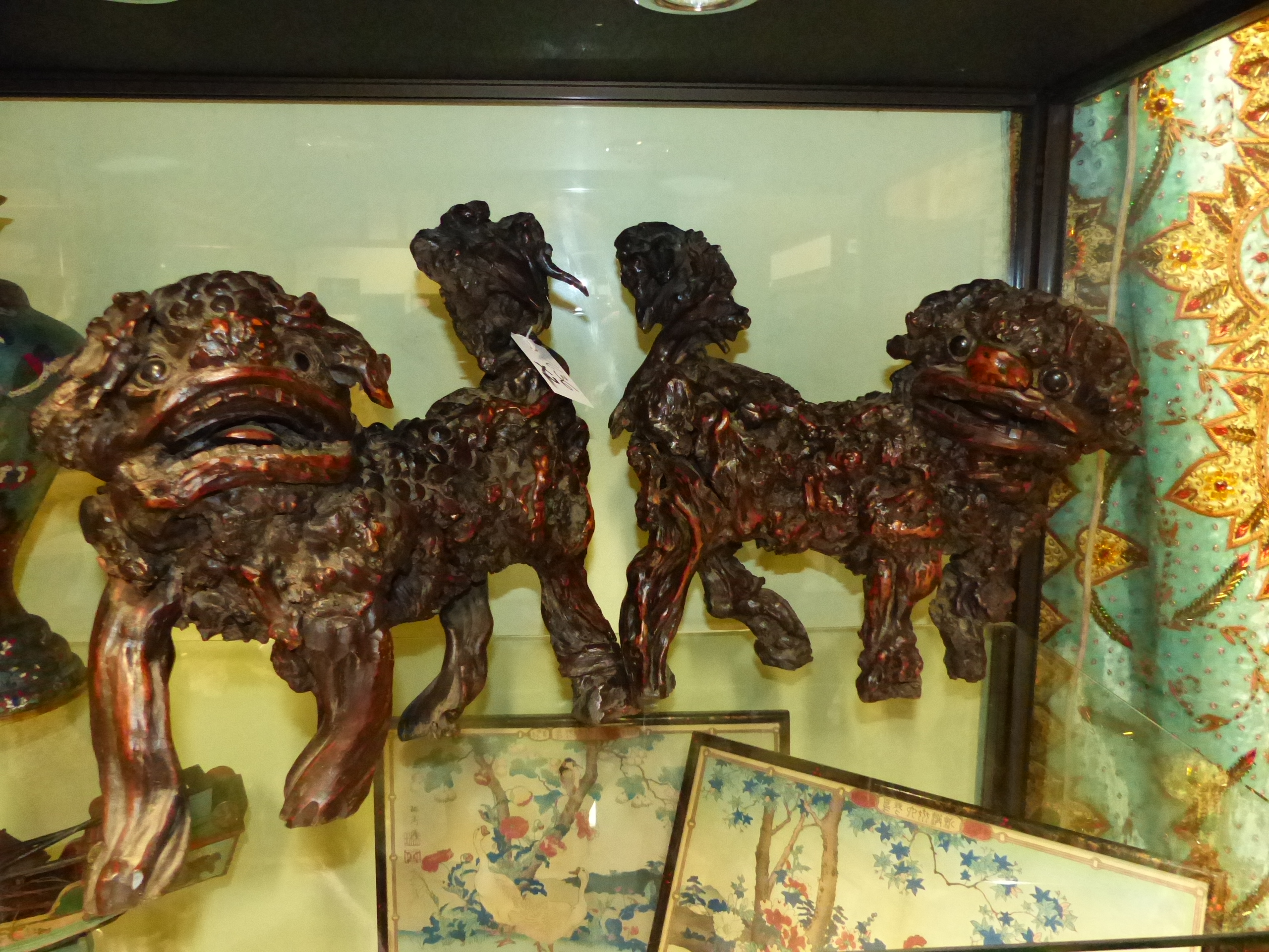 AN UNUSUAL PAIR OF CHINESE CARVED ROOTWOOD FIGURES OF STANDING FOO LIONS.