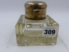 A SILVER MOUNTED GLASS SQUARE SHAPED DESK INKWELL, THE TOP INCORPORATING A SILVER POCKET WATCH.