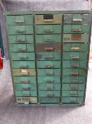 AN UNUSUAL VINTAGE GREEN PAINTED STEEL FRAMED MULTI DRAWER CABINET WITH THIRTY THREE SHORT