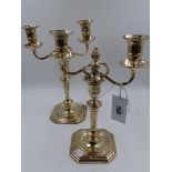 A PAIR OF SILVER TWO BRANCH TALL CANDELABRA WITH SQUARE CANTED BASES AND TAPERED COLUMNS,