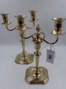 A PAIR OF SILVER TWO BRANCH TALL CANDELABRA WITH SQUARE CANTED BASES AND TAPERED COLUMNS,