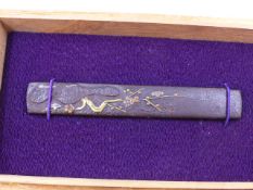 A KOZUKA HANDLE, THE IRON BODY DECORATED WITH CHERRY BLOSSOMS AND HIGHLIGHTED IN COPPER, SILVER