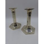 A PAIR OF SILVER HALLMARKED TALL CANDLESTICKS. B'HAM 1915. H.16.5cms.