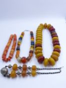 FOUR STRANDS OF NORTH AFRICAN TRIBAL BEAD NECKLACES.