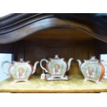 A GARNITURE OF THREE BURGESS & LEIGH EARTHENWARE TEAPOTS AND A STAND DECORATED WITH THE GEISHA