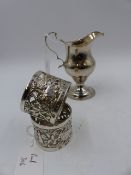 A GEORGE IV SILVER PEDESTAL CREAM JUG LONDON 1828 TOGETHER WITH A PAIR OF PIERCED SILVER NAPKIN