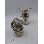 A GEORGE IV SILVER PEDESTAL CREAM JUG LONDON 1828 TOGETHER WITH A PAIR OF PIERCED SILVER NAPKIN