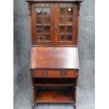 AN INTERESTING LATE 19th.C.ARTS AND CRAFTS OAK BUREAU BOOKCASE WITH GLAZED PANEL DOORS AND PAINTED