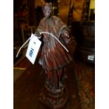 AN EARLY CONTINENTAL CARVED FIGURE OF A CLERIC IN FLOWING ROBES ON STEPPED BASE. H.29cms.