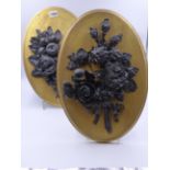 A PAIR OF UNUSUAL ANTIQUE LEAD REPOUSSE FLORAL AND FRUIT BUNCHES MOUNTED ON OVAL PANELS. H.40cms.