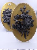 A PAIR OF UNUSUAL ANTIQUE LEAD REPOUSSE FLORAL AND FRUIT BUNCHES MOUNTED ON OVAL PANELS. H.40cms.