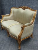 A CARVED GILTWOOD LOUIS XV STYLE SETTEE WITH MOULDED FRAME AND FLORAL MOTIFS. W.132cms.