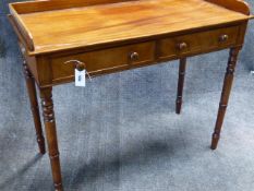 A MAHOGANY EARLY VICTORIAN GALLERY BACK TWO DRAWER WRITING TABLE WITH RING TURNED TAPERED LEGS. W.