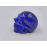 A TIBETAN BLUE CARVED HARDSTONE MODEL OF A SKULL. H.5cms.