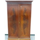 A 19th.C.MAHOGANY HANGING WARDROBE WITH CROSSBANDED AND IINLAID PANEL DOORS STANDING ON PLINTH BASE.