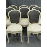 A SET OF EIGHT CARVED FRENCH LOUIS XV STYLE DINING CHAIRS WITH SHAPED BACKS AND SEATS ON CABRIOLE