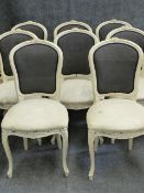 A SET OF EIGHT CARVED FRENCH LOUIS XV STYLE DINING CHAIRS WITH SHAPED BACKS AND SEATS ON CABRIOLE