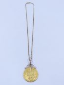 A SPADE GUINEA COIN MOUNTED AS A PENDANT WITH A SCROLL TOP SUSPENDED ON A 9ct GOLD BELCHER CHAIN (