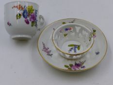 A MEISSEN CUP AND SAUCER PAINTED WITH SPRAYS OF WILD FLOWERS.